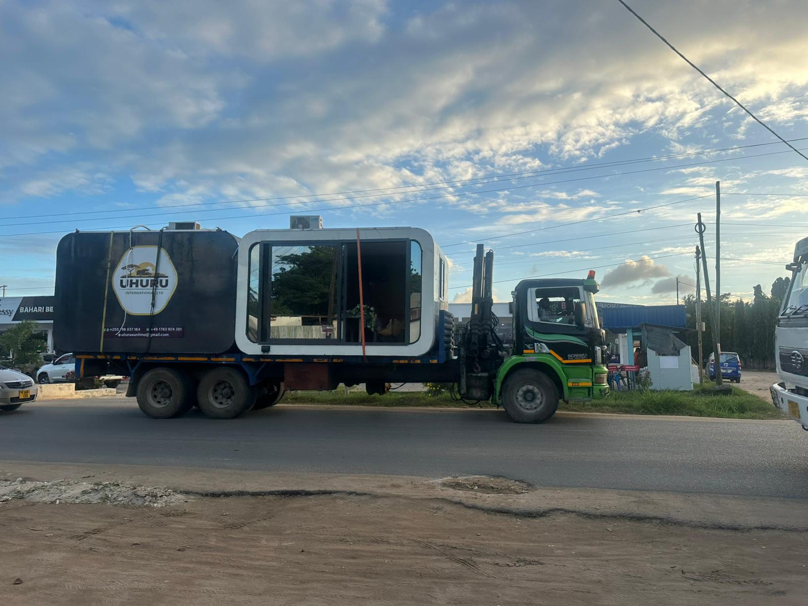 Capsule home unit on a flatbed truck during delivery